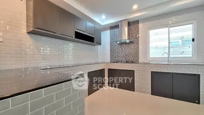 Modern kitchen with sleek cabinetry and gas stove in a stylish home