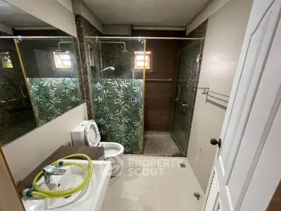 Modern bathroom with glass shower and stylish tile design