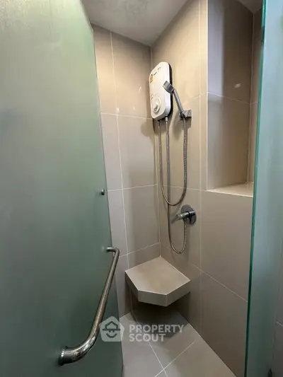 Modern bathroom with sleek shower design and built-in seat, featuring contemporary fixtures.