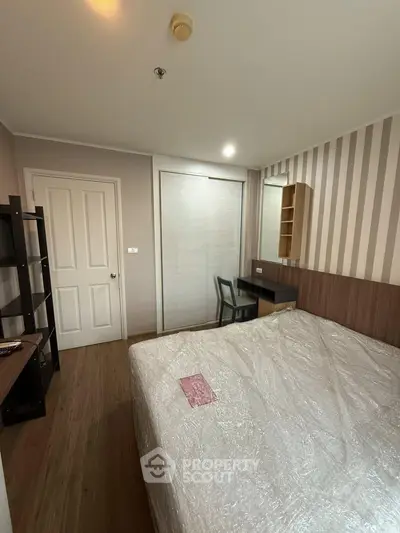 Cozy bedroom with modern decor and ample storage space, perfect for comfortable living.