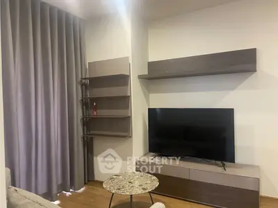 Modern living room with sleek TV setup and stylish shelving
