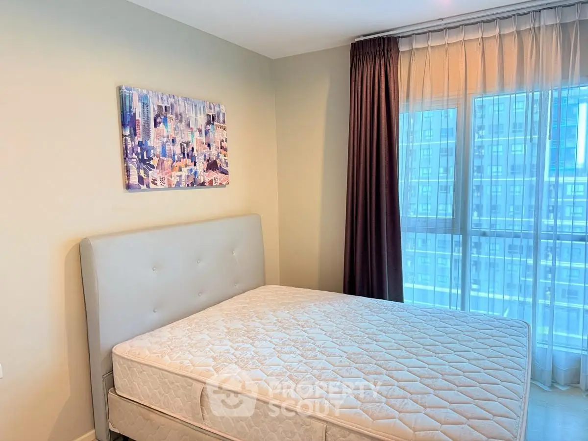 Modern bedroom with large window and city view, featuring a comfortable bed and stylish decor.
