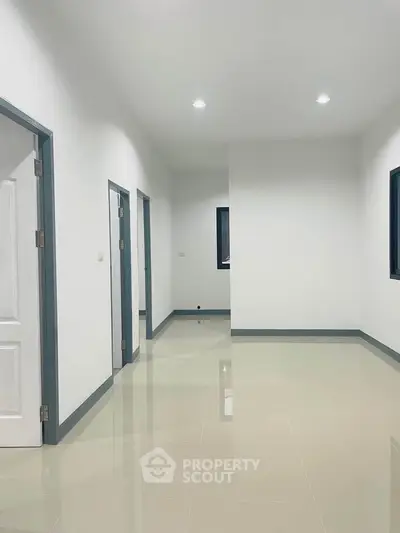 Spacious modern hallway with sleek tile flooring and minimalist design