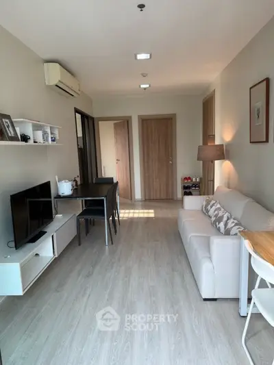 Modern living room with sleek furniture and natural light, perfect for cozy gatherings.