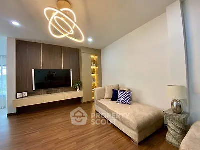 Modern living room with stylish lighting and cozy seating area, perfect for relaxation and entertainment.