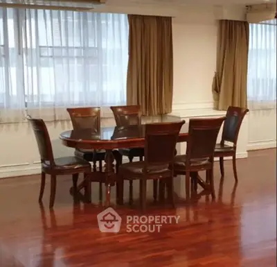 Elegant dining room with polished wooden floors and classic dining set