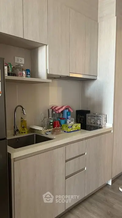 Modern kitchen with sleek cabinetry and compact appliances, perfect for urban living.