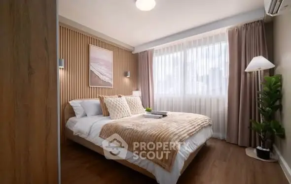 Elegant bedroom with cozy decor and large window in modern apartment