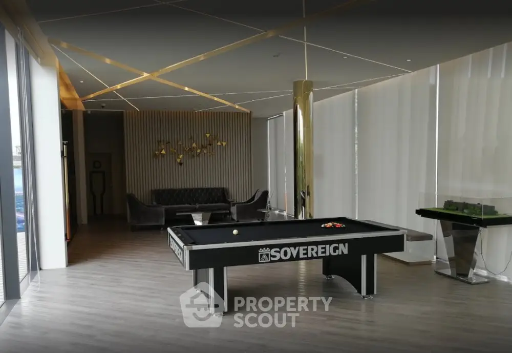Luxurious common area with pool table and modern decor in upscale building.