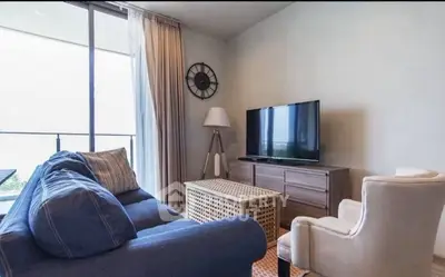 Cozy living room with modern furniture and large window offering natural light.