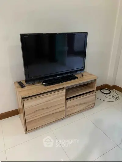 Modern living room with sleek TV stand and flat-screen television, perfect for entertainment setup.