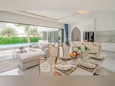 Luxurious open-plan living room with elegant dining area and pool view
