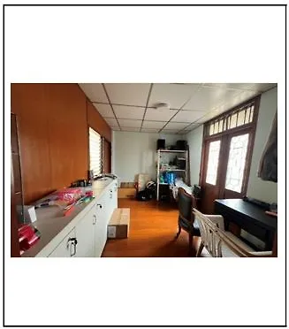 Spacious study room with wooden flooring and ample natural light, perfect for a home office setup.