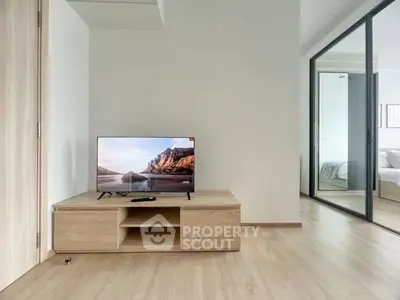Modern living room with sleek wooden TV stand and glass sliding doors