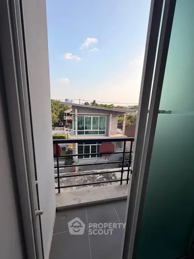 Charming balcony view of modern residential building with clear skies.