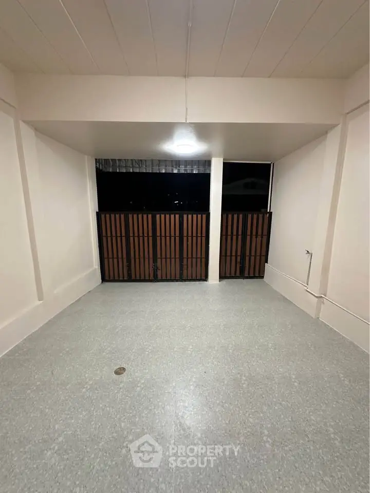 Spacious balcony with secure railing and night view, perfect for relaxation or entertaining guests.