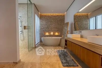Luxurious modern bathroom with freestanding tub and elegant stone wall accents.