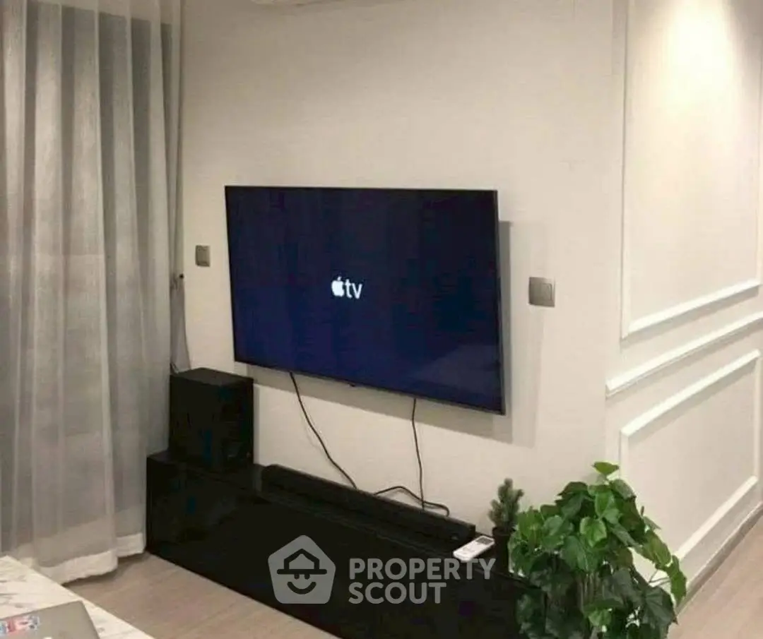 Modern living room with wall-mounted TV and stylish decor