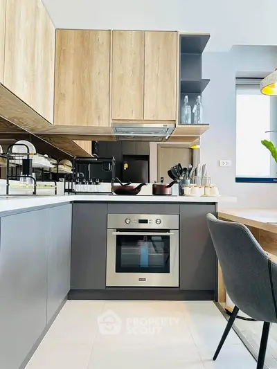 Modern kitchen with sleek cabinetry and built-in oven, perfect for culinary enthusiasts.