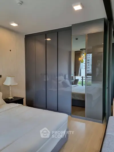 Modern bedroom with sleek wardrobe and balcony view