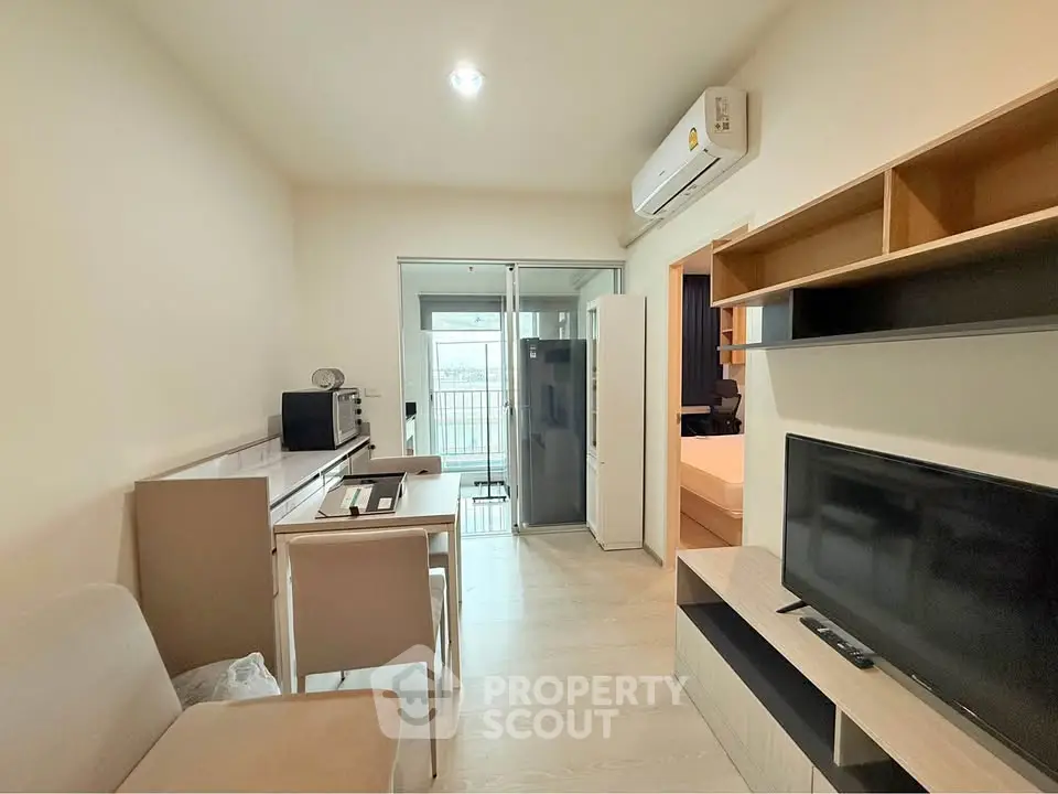 Modern living room with sleek furniture and balcony view, perfect for urban living.