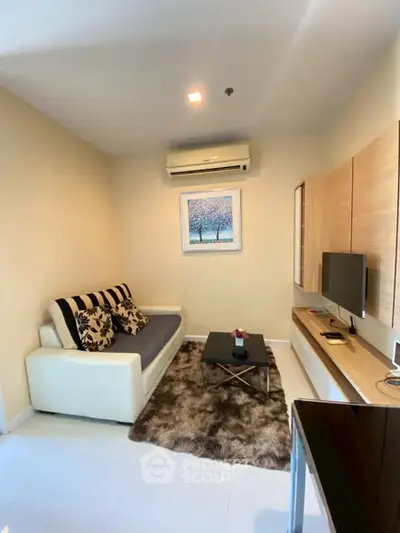 Cozy living room with modern decor and air conditioning in a stylish apartment.