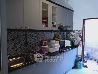 Modern kitchen with mosaic backsplash and sleek cabinetry