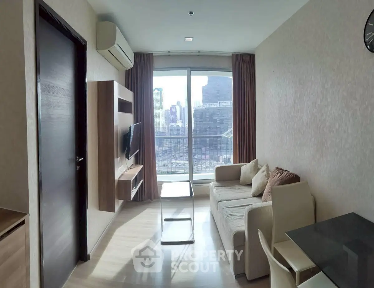 Modern living room with city view, featuring sleek furniture and large window for natural light.