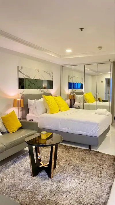 Luxurious bedroom with mirrored wardrobe and stylish decor in modern apartment