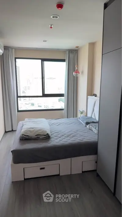 Modern bedroom with city view and sleek storage solutions