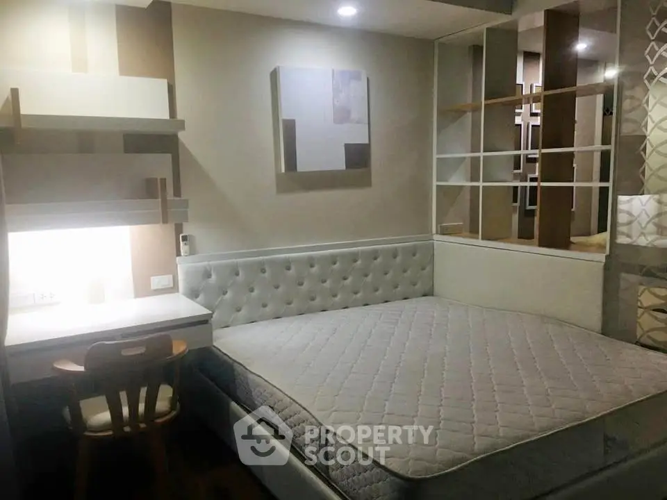 Modern bedroom with stylish decor and built-in desk, perfect for urban living.