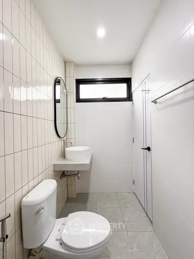 Modern minimalist bathroom with sleek fixtures and neutral tiles