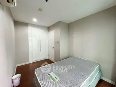 Spacious bedroom with modern wardrobe and cozy ambiance, perfect for restful nights.