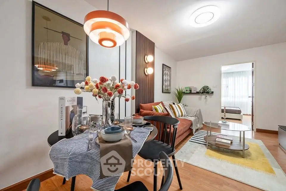 Stylish open-plan living and dining area with modern decor and cozy ambiance.
