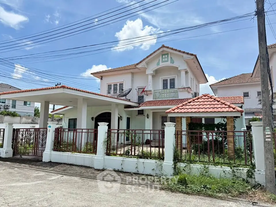 Charming two-story house with tiled roof and spacious driveway in a serene neighborhood.