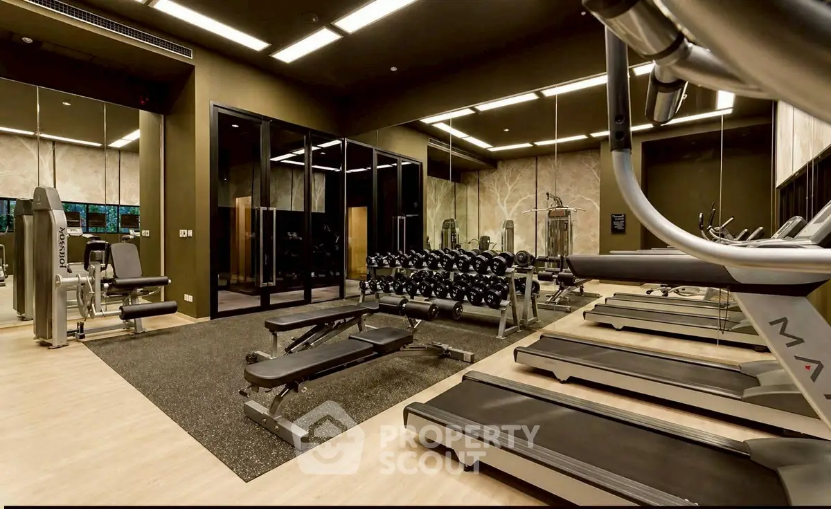 Luxurious gym with modern equipment in upscale residential building