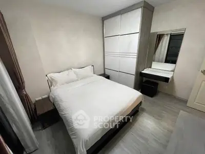 Cozy bedroom with modern furnishings and ample storage space
