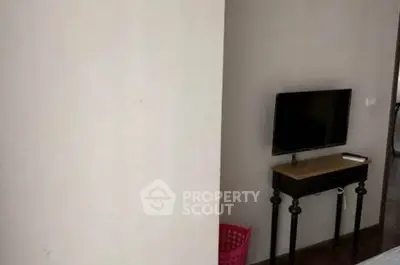Cozy living room corner with wall-mounted TV and stylish console table.