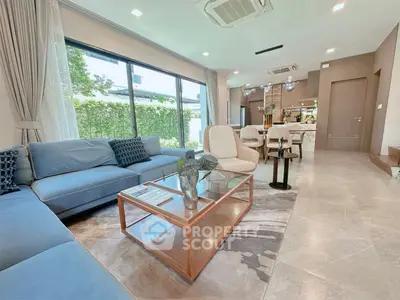 Luxurious open-plan living room with elegant decor and garden view, perfect for modern family living.