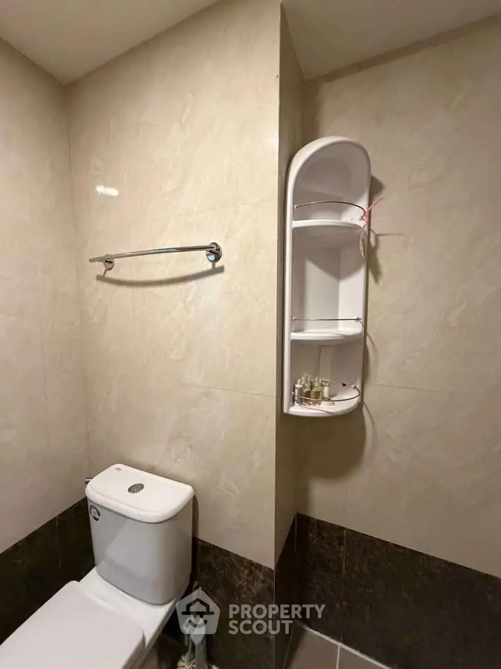 Modern bathroom with sleek design and wall-mounted storage unit.