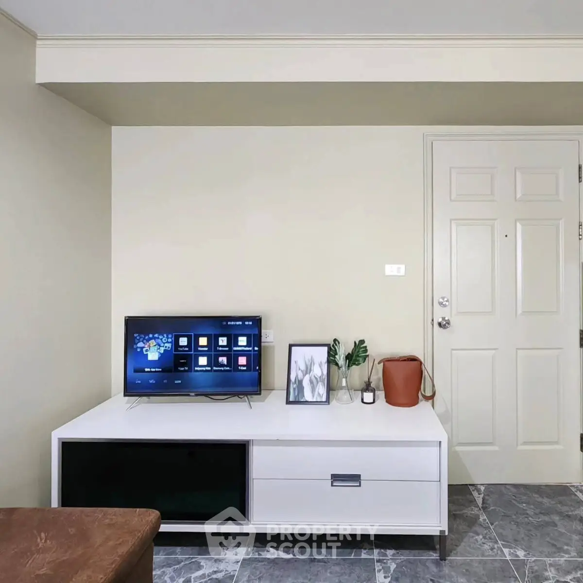 Modern living room with sleek TV stand and marble flooring
