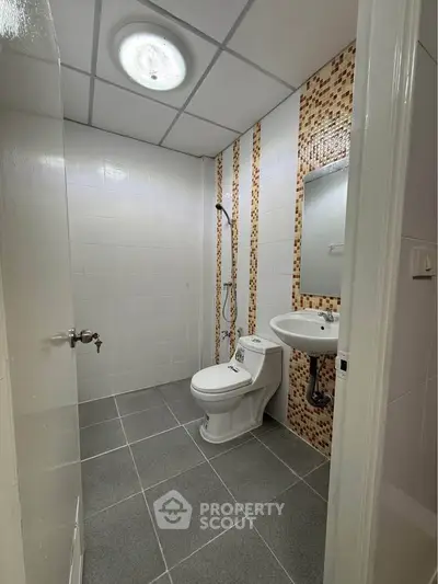 Modern bathroom with sleek fixtures and stylish tile accents, perfect for a contemporary home.