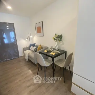 Cozy living room with modern decor and dining area, perfect for urban living.
