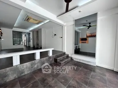 Spacious modern interior with elevated platform and sleek design, perfect for versatile living or office space.