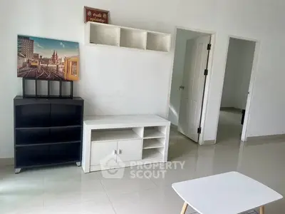 Modern living room with sleek furniture and wall art, showcasing minimalist design.