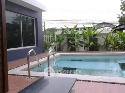 Luxurious private pool area with modern design and lush greenery, perfect for relaxation and entertainment.