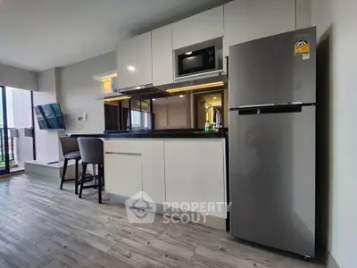 Modern kitchen with sleek appliances and open layout in stylish apartment