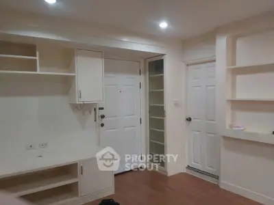 Modern apartment entrance with built-in storage and wooden flooring