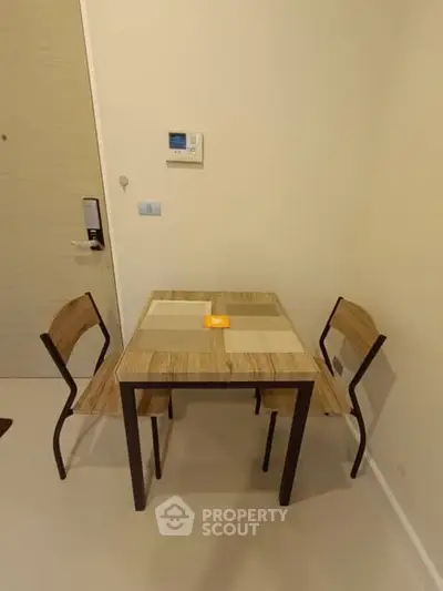 Cozy dining area with modern table and chairs in a compact space.