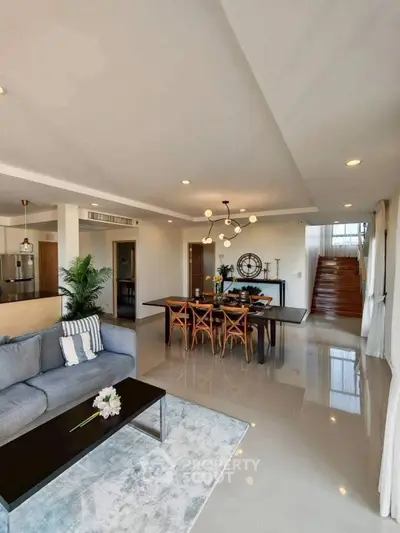 Spacious modern living room with elegant dining area and stylish decor